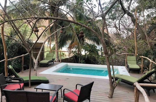 Arroyo Cruz House | Great room with deck pool in front of perfect bay